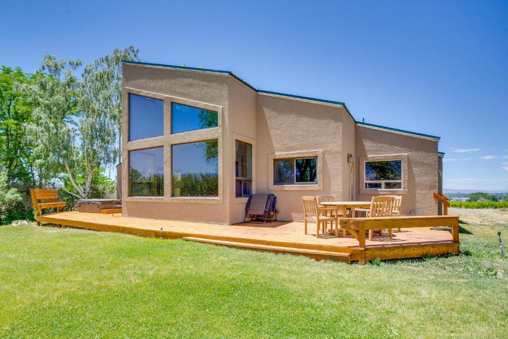 a tiny house with a deck and a table at Hot Tub, Wineries, Mtn Views Palisade Home! in Palisade