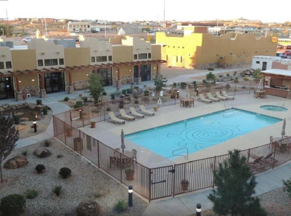 an outdoor pool with chairs and a resort at Moenkopi Legacy Inn & Suites in Tuba City