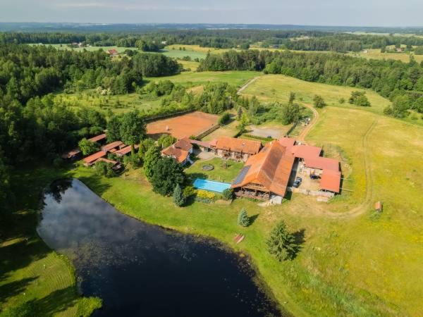an aerial view of a house on a island in the water at Agroturystyka "Dworek u Pelców" in Ryn