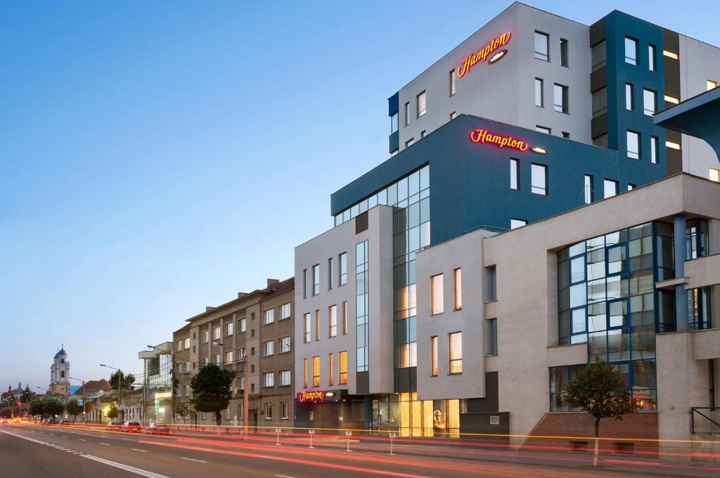 a building on the side of a street at Hampton by Hilton Cluj-Napoca in Cluj-Napoca