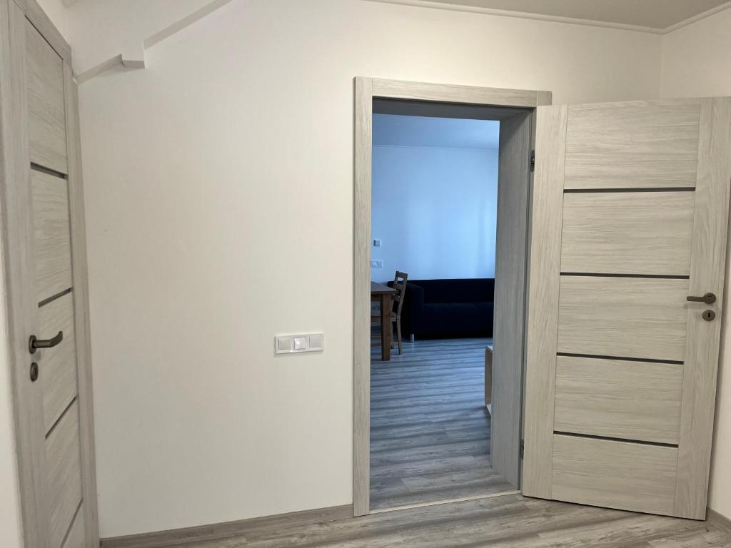 a hallway with a door open to a room at Kozákov Apartmány - první patro 
