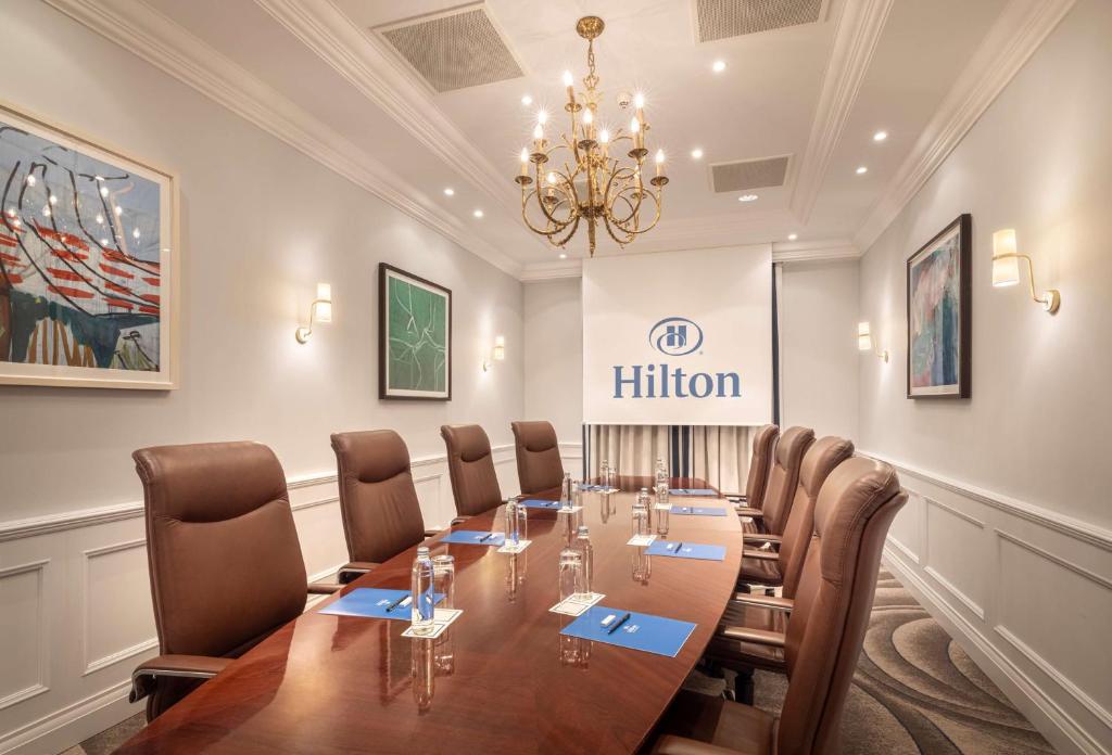 a conference room with a long table and chairs at Hilton Imperial Dubrovnik in Dubrovnik
