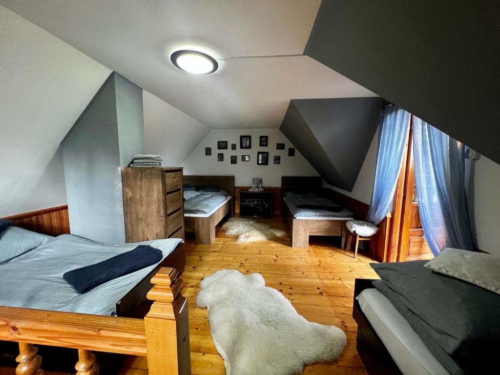 a attic room with a bed and a dormer at Domek pod Modrzewiem in Nowy Targ