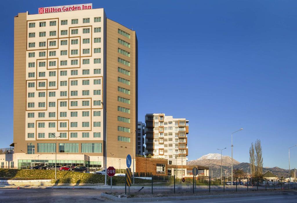 a tall white building with a stop sign in front of it at Hilton Garden Inn Isparta in Isparta