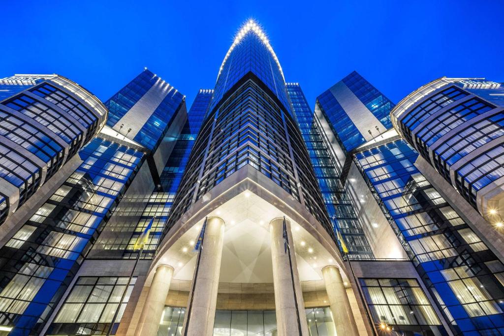 a tall building with a blue sky in the background at Hilton Kyiv in Kyiv