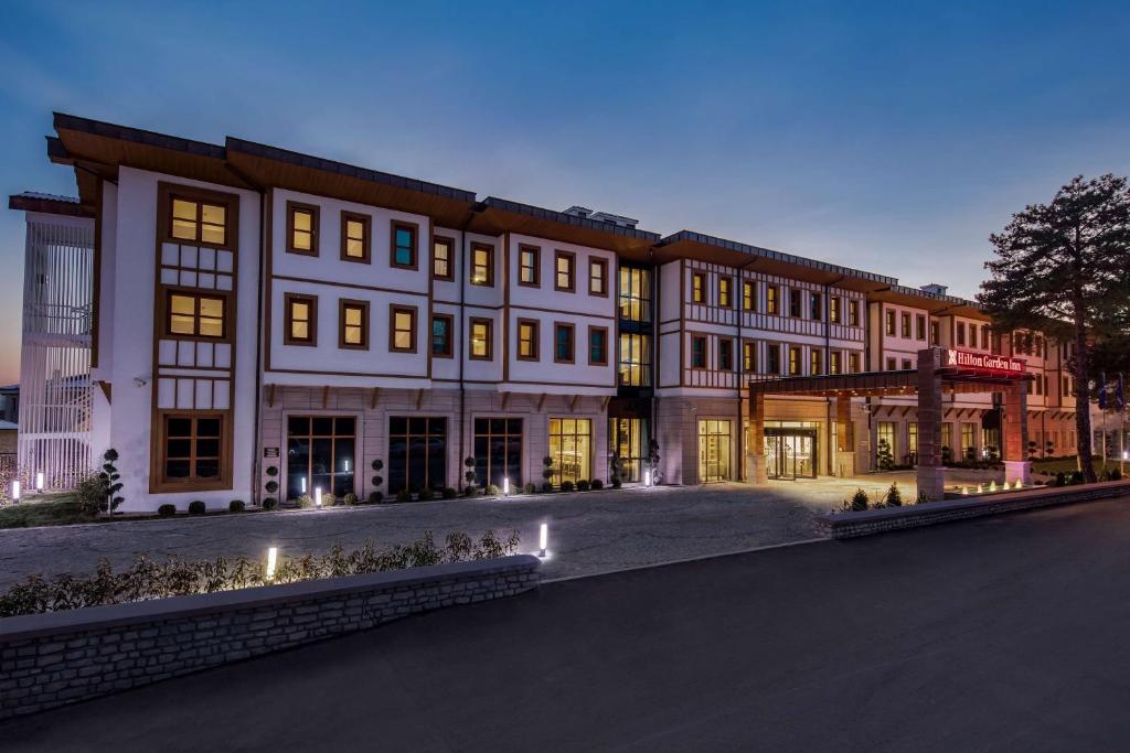 a large building with many windows on a street at Hilton Garden Inn Safranbolu in Safranbolu