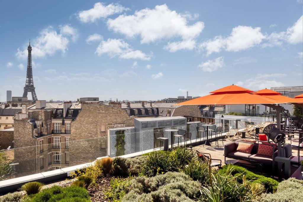 a patio with a view of the eiffel tower at Canopy By Hilton Paris Trocadero in Paris