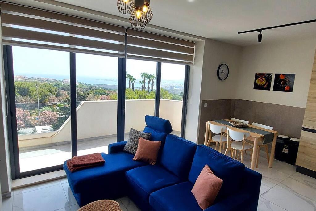 a living room with a blue couch and a table at 2-bed apartment in Mellieha in Mellieħa