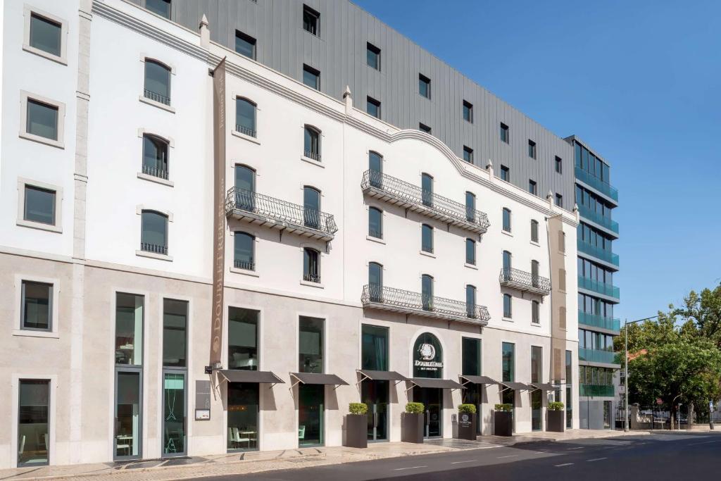 a large white building on a city street at DoubleTree by Hilton Lisbon Fontana Park in Lisbon