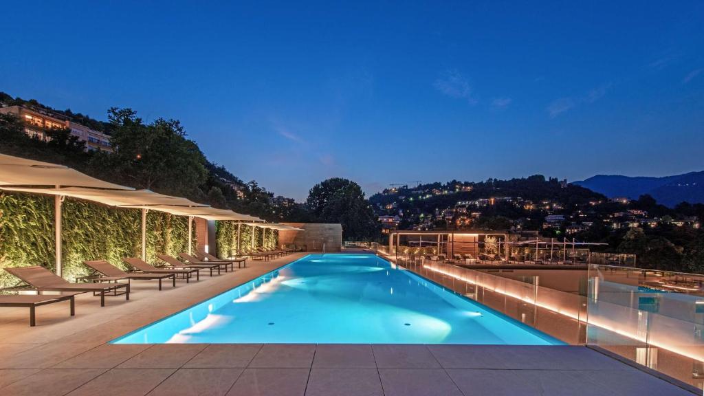 a swimming pool on the roof of a building at Hilton Lake Como in Como