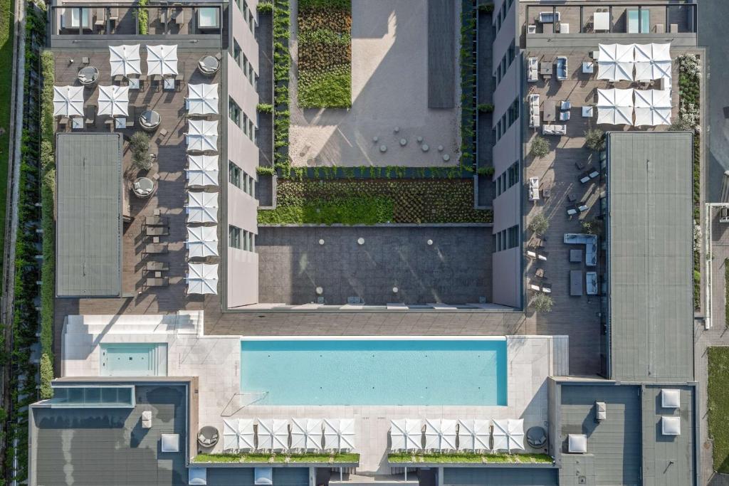 an overhead view of a building with a swimming pool at Hilton Lake Como in Como