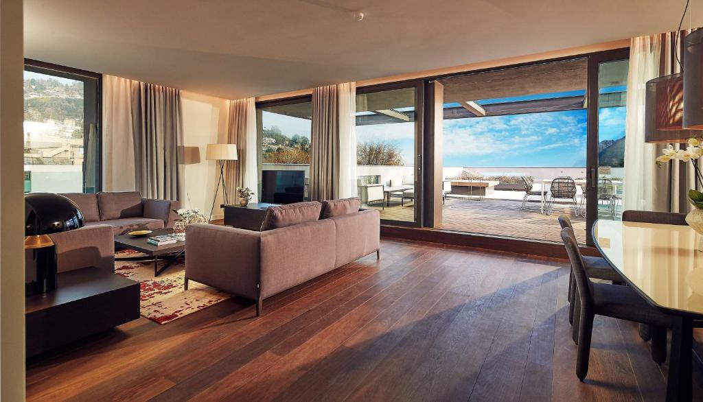 a living room with a couch and a table at Hilton Lake Como in Como