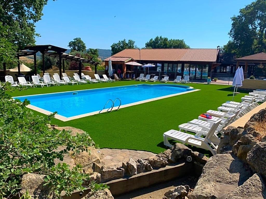 - une piscine avec des chaises longues et un complexe dans l'établissement Agriturismo Cervinace, à Oriolo