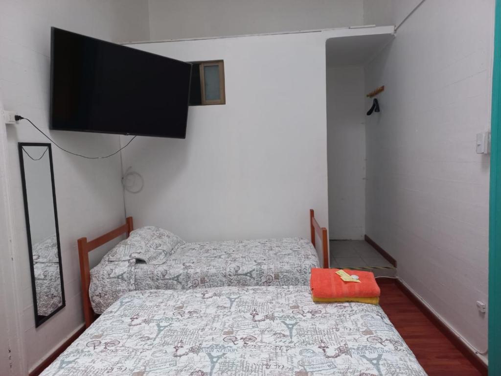 Postel nebo postele na pokoji v ubytování HOSTAL BAQUEDANO IQUIQUE