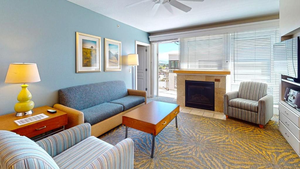 a living room with a couch and a fireplace at WorldMark Seaside by BookTimeShares in Seaside
