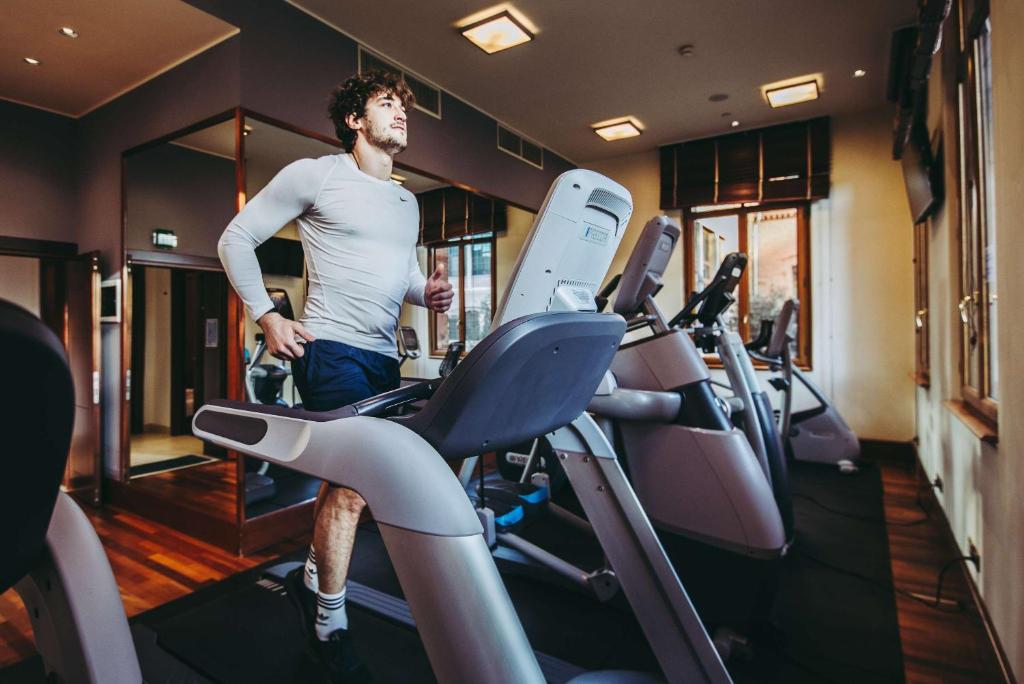 a man standing on a treadmill in a gym at Hilton Molino Stucky Venice in Venice