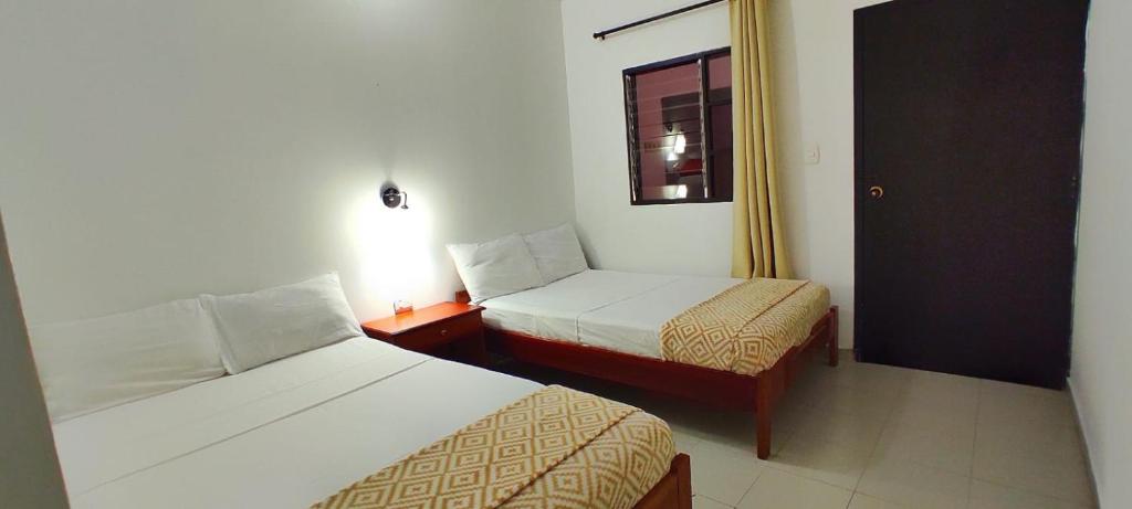 A bed or beds in a room at HOTEL BUGANVILIA