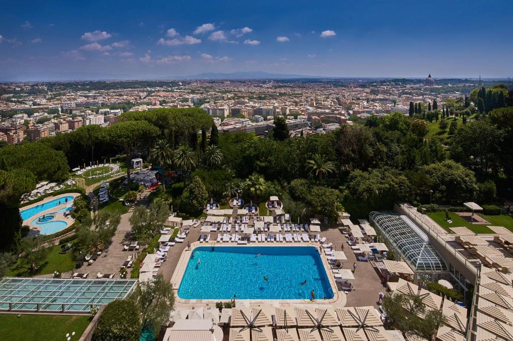 an overhead view of a swimming pool and a city at Rome Cavalieri, A Waldorf Astoria Hotel in Rome