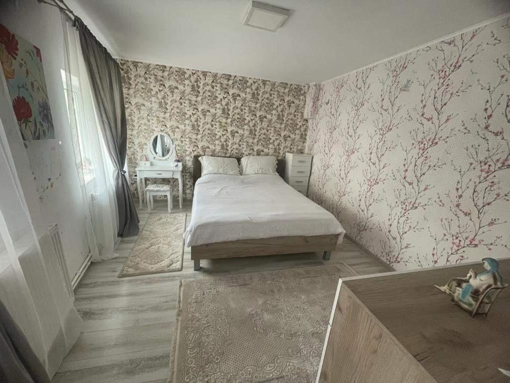 a bedroom with a bed and a table in it at Casa Ancuta Eforie Sud in Eforie Sud