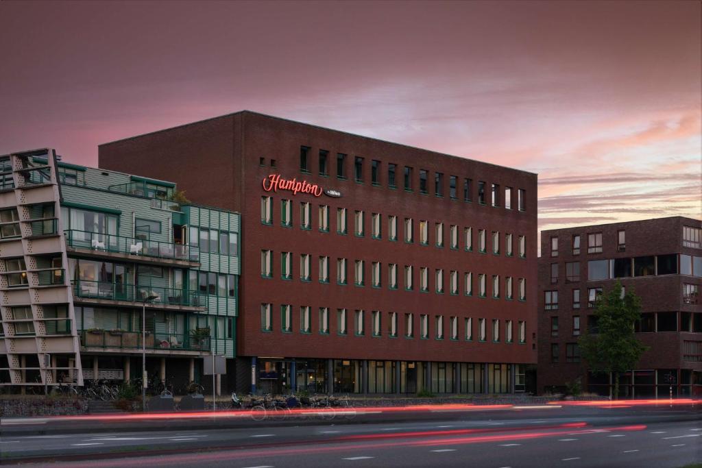 een gebouw met een bord aan de zijkant bij Hampton by Hilton Amsterdam Centre East in Amsterdam