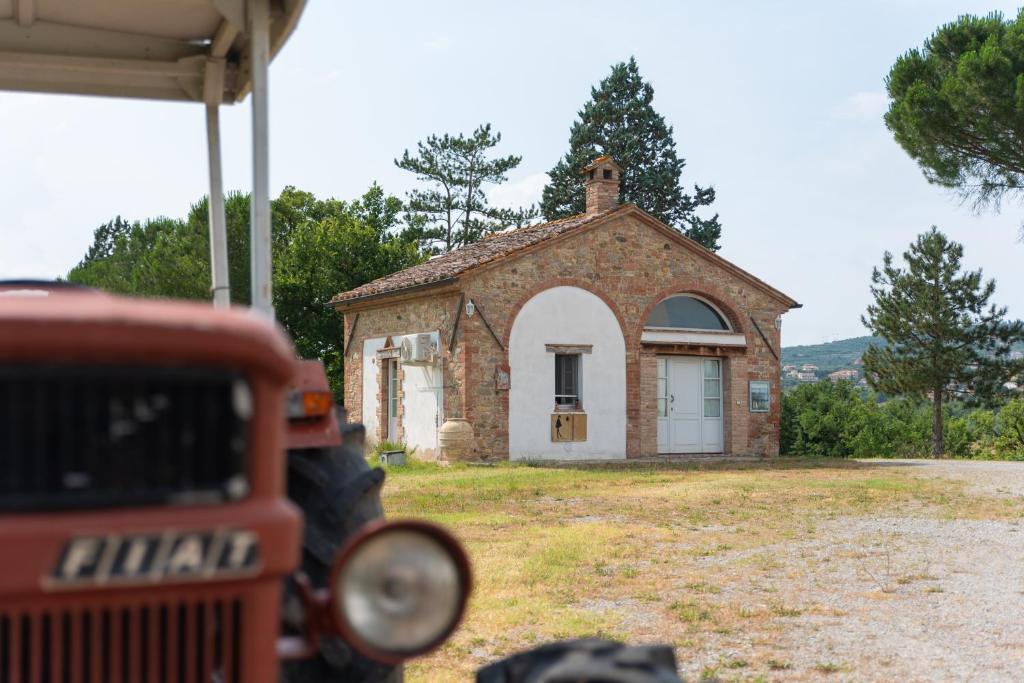 an old brick building with a small chapel in front of it at Opera d'Oro in Piegaro