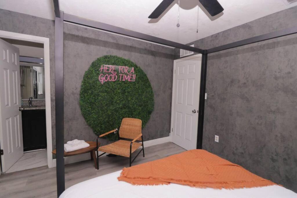 a bedroom with a bed and a sign on the wall at Stylish & Comfy Central Location in Orlando