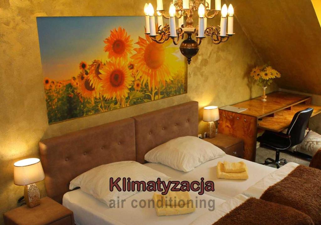 a bedroom with a bed with a painting on the wall at Arkady in Słupsk