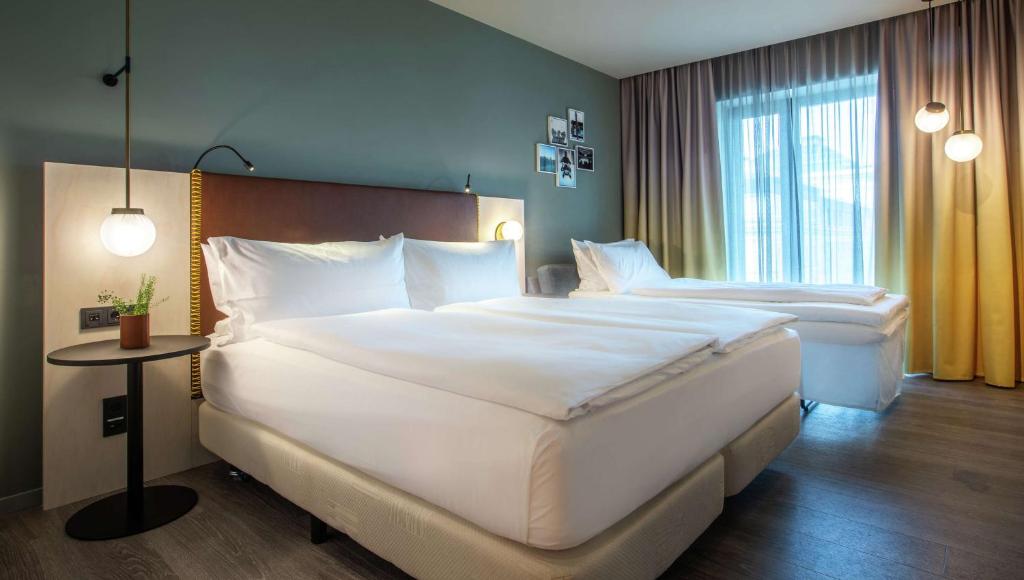 Postel nebo postele na pokoji v ubytování Hilton Garden Inn Mannheim