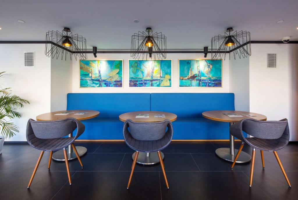 a row of tables and chairs in a waiting room at Hampton by Hilton Istanbul Kurtkoy in Istanbul