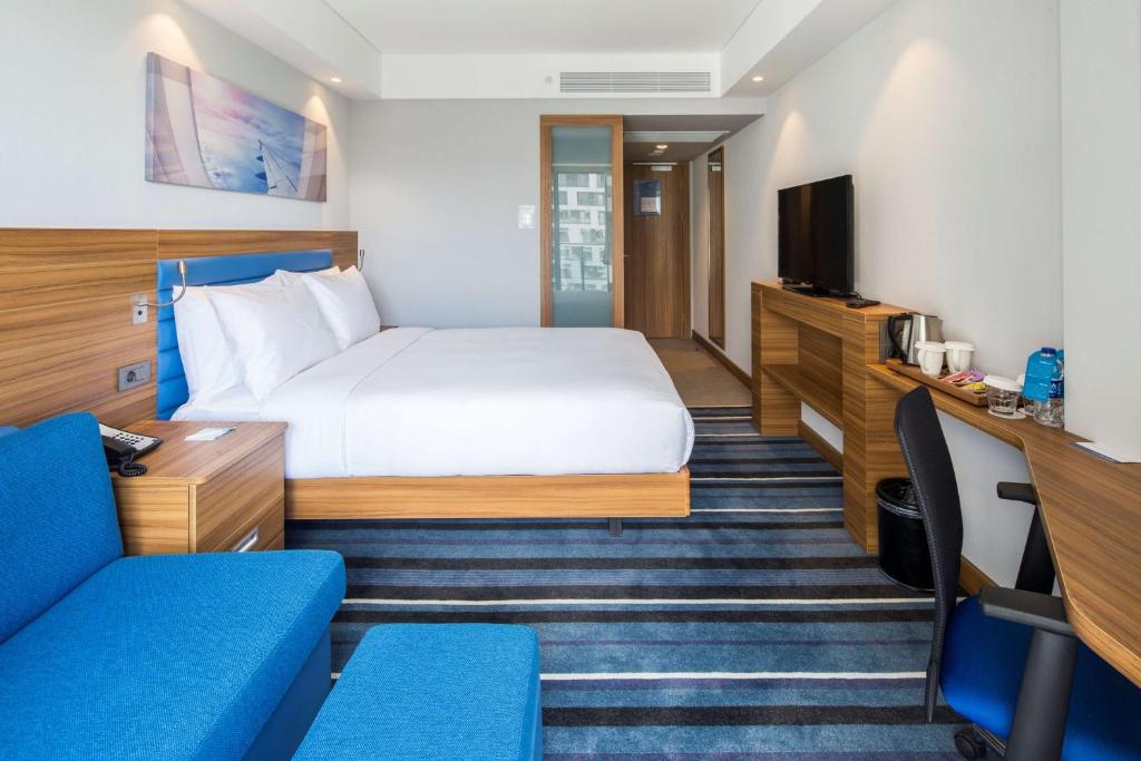 a hotel room with a bed and a tv at Hampton by Hilton Istanbul Kurtkoy in Istanbul