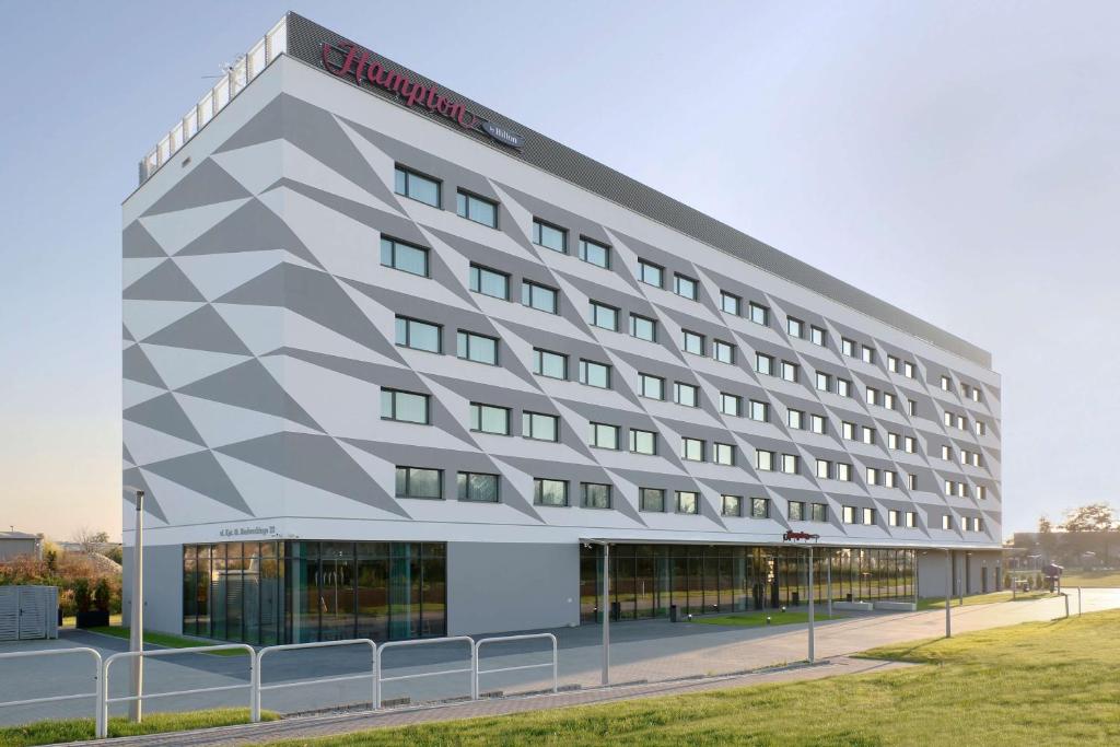 a rendering of a hotel building at Hampton by Hilton Krakow Airport in Balice