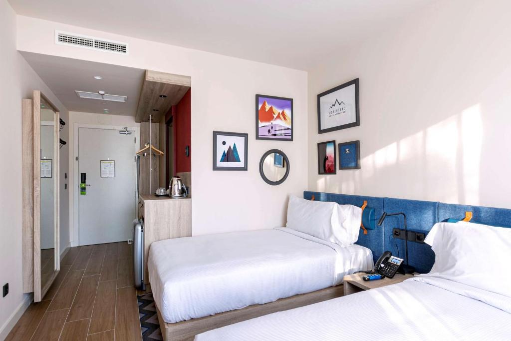 A bed or beds in a room at Hampton By Hilton Alcobendas Madrid
