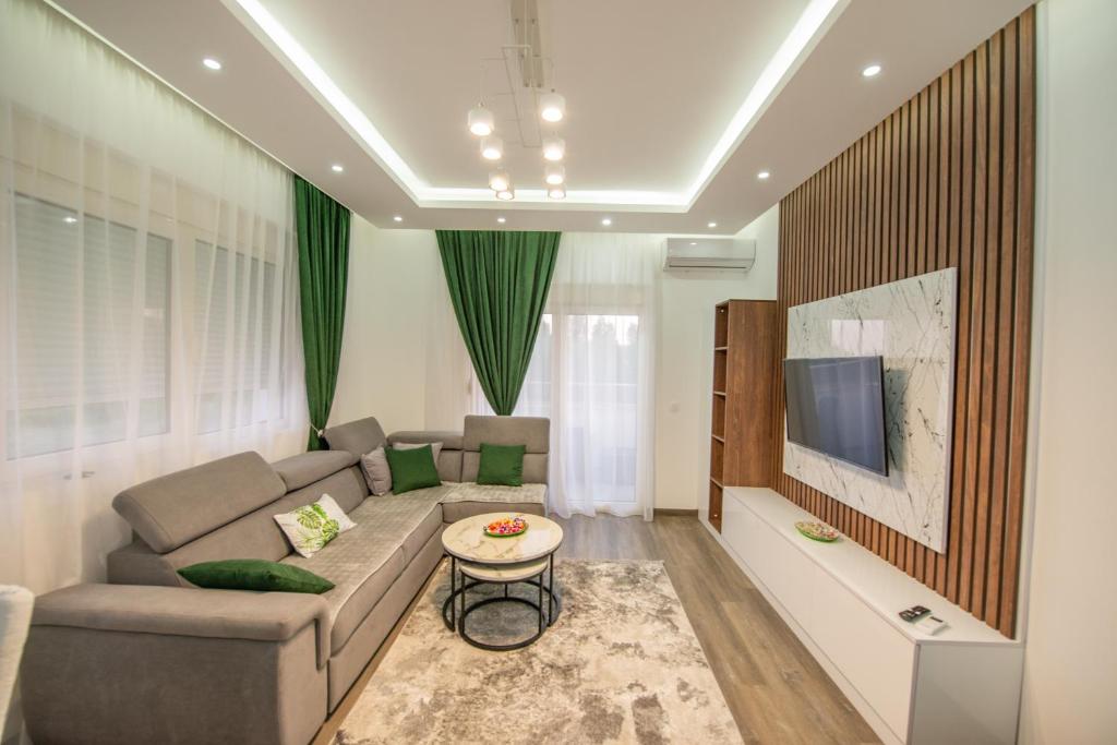 a living room with a couch and a tv at Apartment Lara in Ulcinj