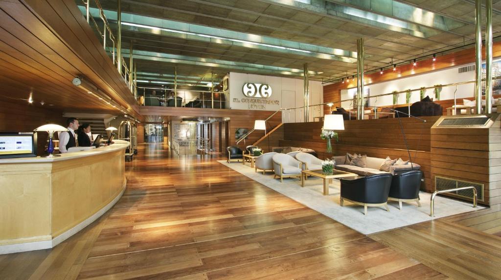 a lobby of a store with a bar and chairs at El Conquistador Hotel in Buenos Aires