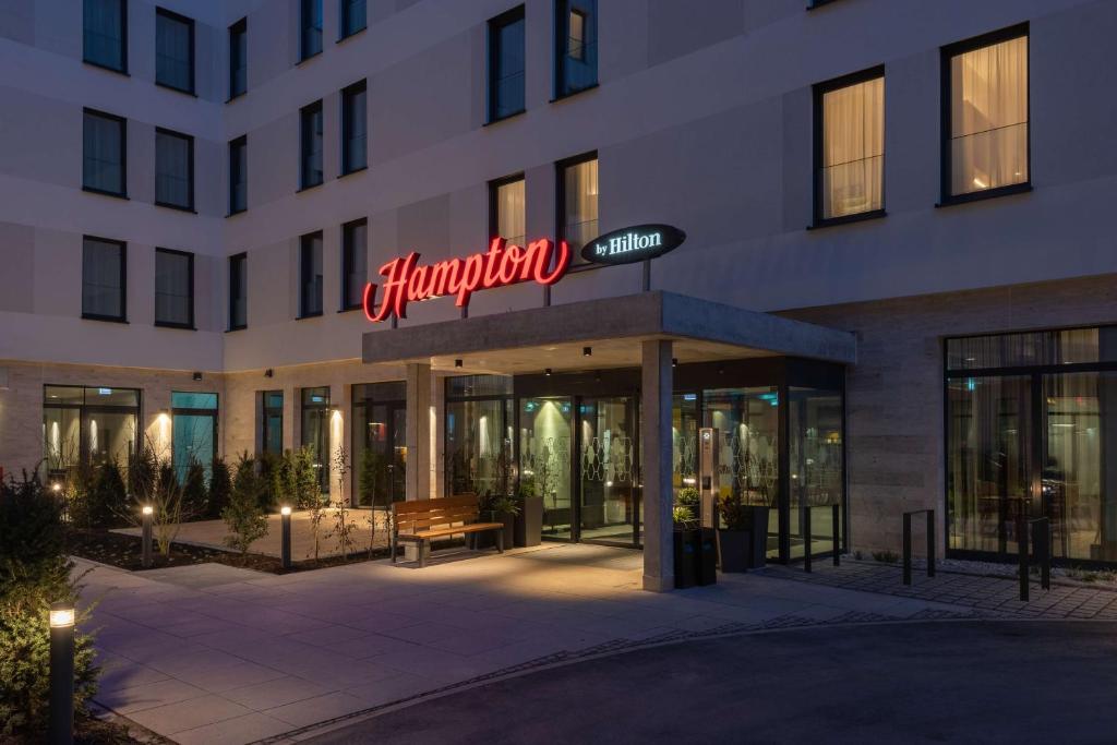 慕尼黑的住宿－Hampton By Hilton Munich City North，前面有标志的建筑