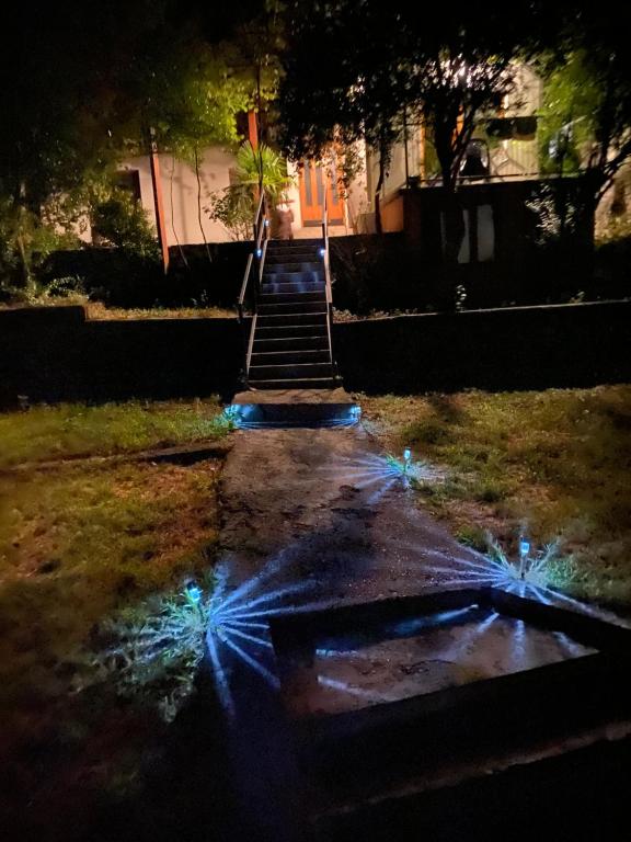 a stairway with lights on the ground at night at Stolac Home River in Stolac