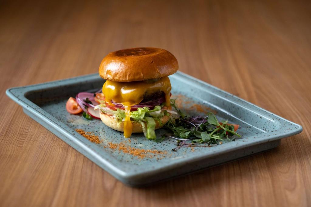 a sandwich on a plate on a table at Hampton by Hilton Riga Airport in Riga