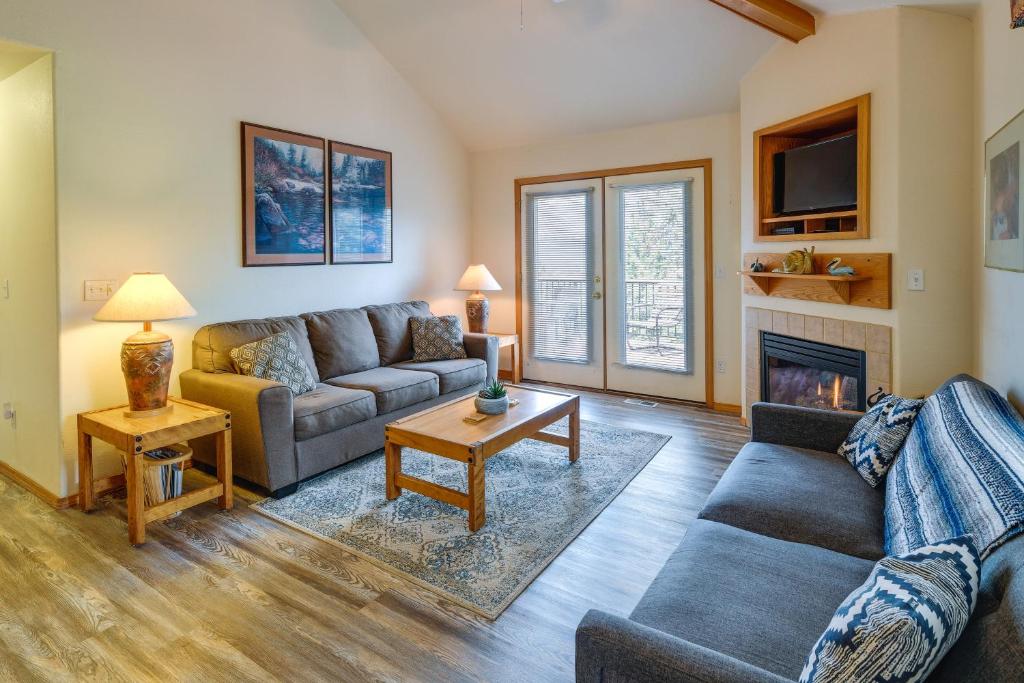a living room with a couch and a fireplace at Resort-Style Klamath Falls Home, Golf Course View! in Klamath Falls