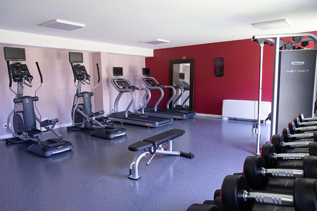 a gym with several treadmills and exercise bikes at Hampton By Hilton Toulouse Airport in Blagnac