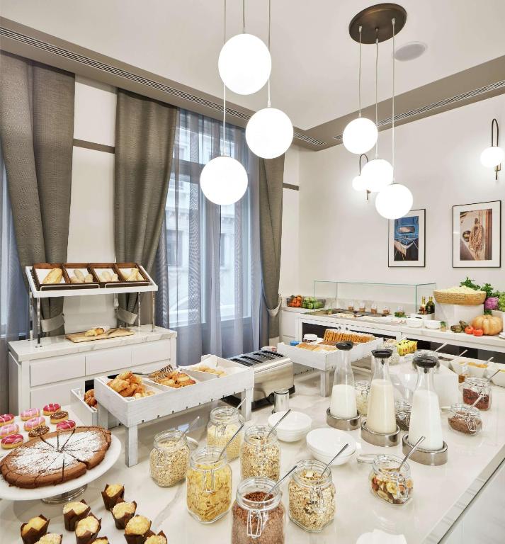 a buffet line with many different types of pastries at DoubleTree By Hilton Trieste in Trieste