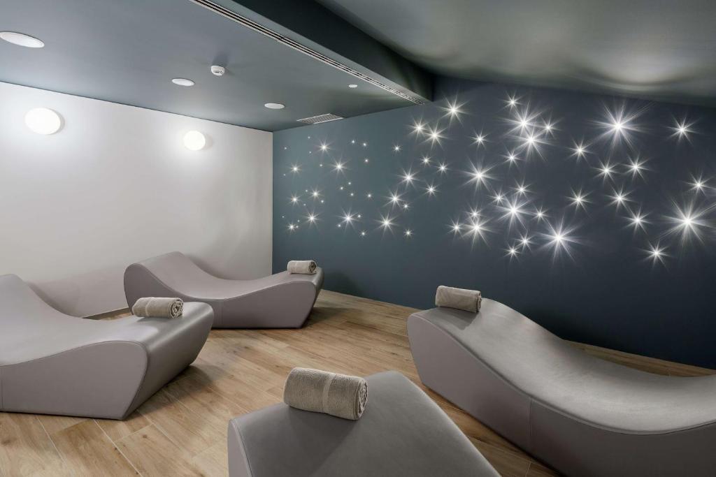 a waiting room with chairs and a wall with stars at DoubleTree By Hilton Trieste in Trieste