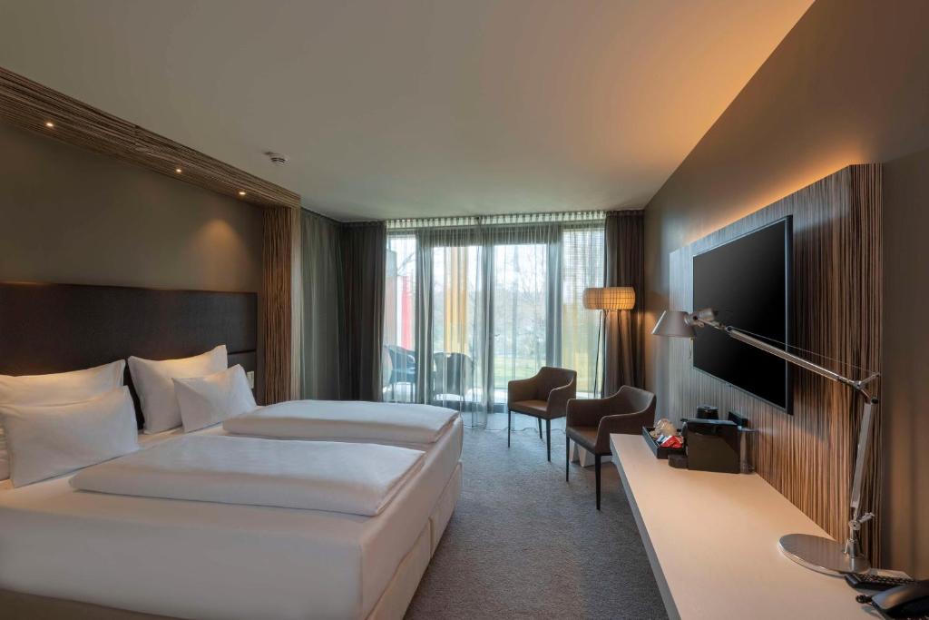 A television and/or entertainment centre at Doubletree by Hilton Vienna Schonbrunn