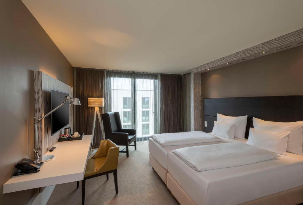 A bed or beds in a room at Doubletree by Hilton Vienna Schonbrunn