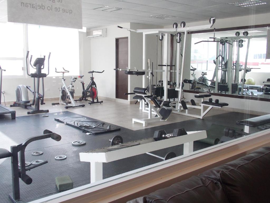 een fitnessruimte met diverse loopbanden en hometrainers bij Suite Lof 206 in Monterrey