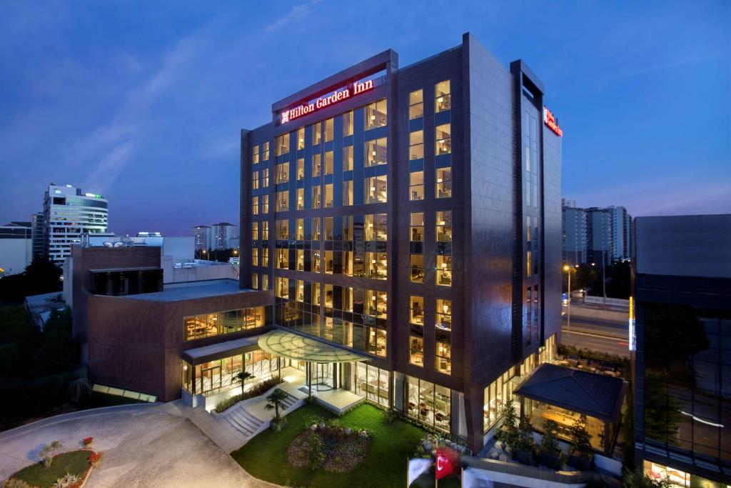 a tall building with a sign on top of it at Hilton Garden Inn Istanbul Beylikduzu in Istanbul