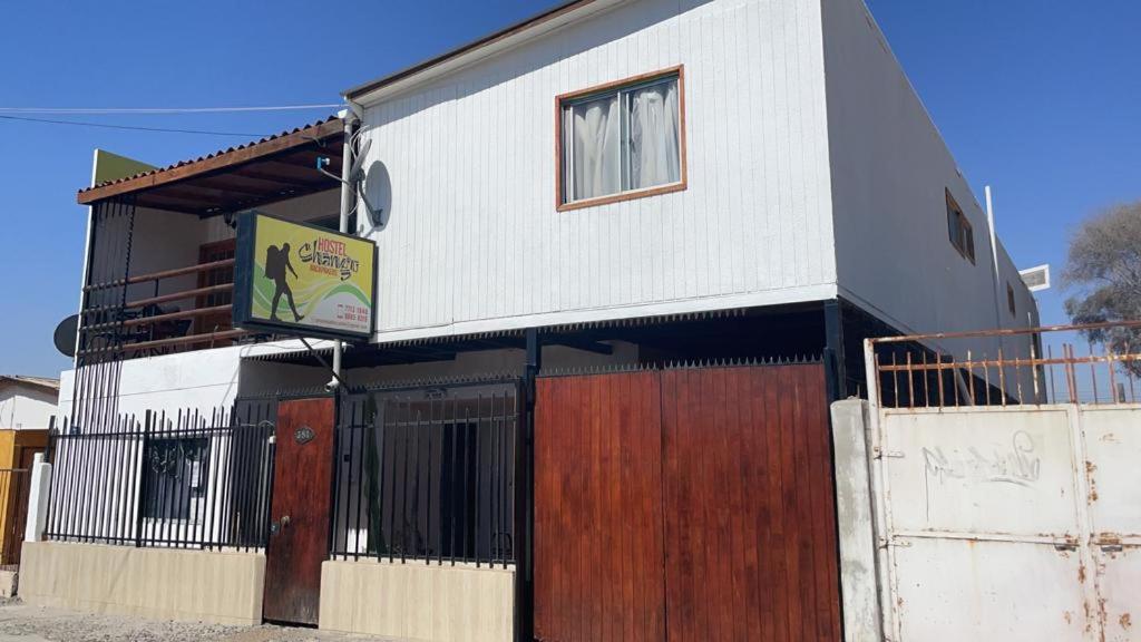 a building with a sign on the side of it at Hostel Chango in Caldera