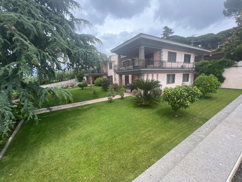 a house with a green lawn in front of it at Villa Paradiso - Castel Gandolfo in Marino
