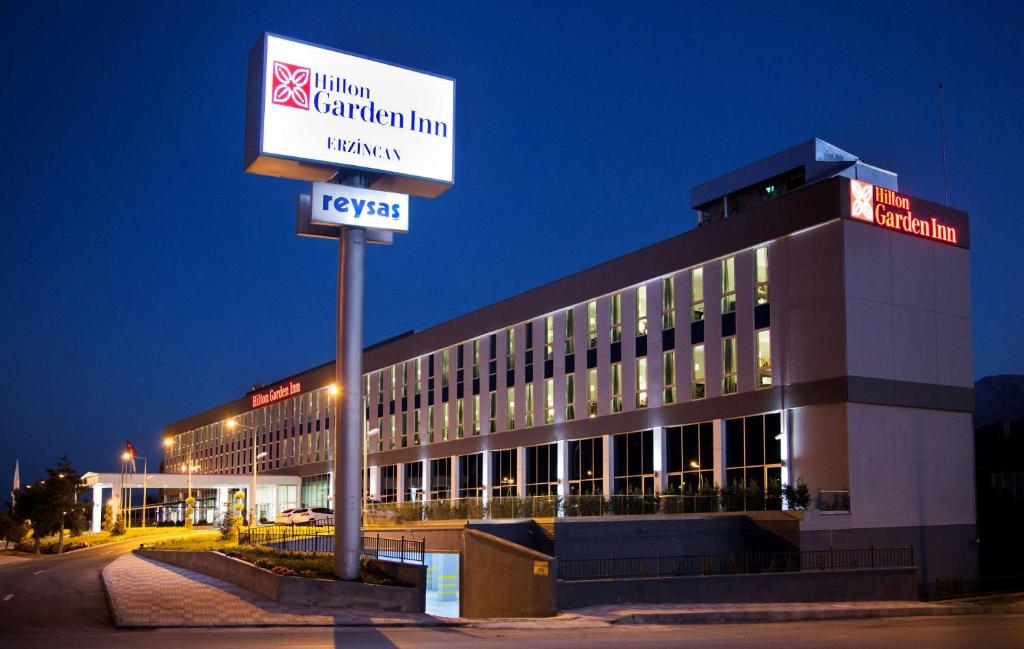 a building with a sign in front of it at Hilton Garden Inn Erzincan in Erzincan