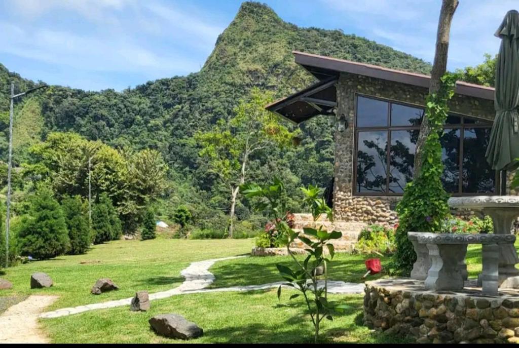 a stone house with a mountain in the background at PIKA CABINS 2 in San Carlos