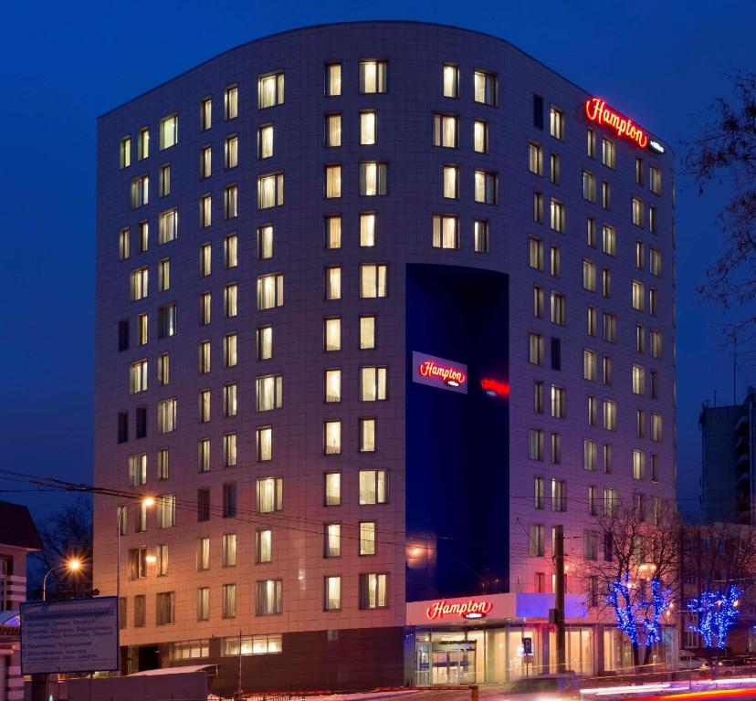 a building with a sign on the side of it at Hampton by Hilton Voronezh in Voronezh